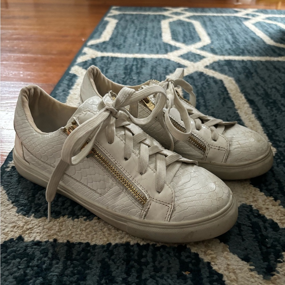 White and gold sneakers